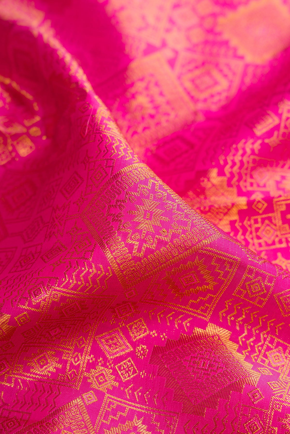 Close up of Pure Silk Pink Kanchipuram Saree with Zari Brocade on the body and Zari Border.  displaying folds