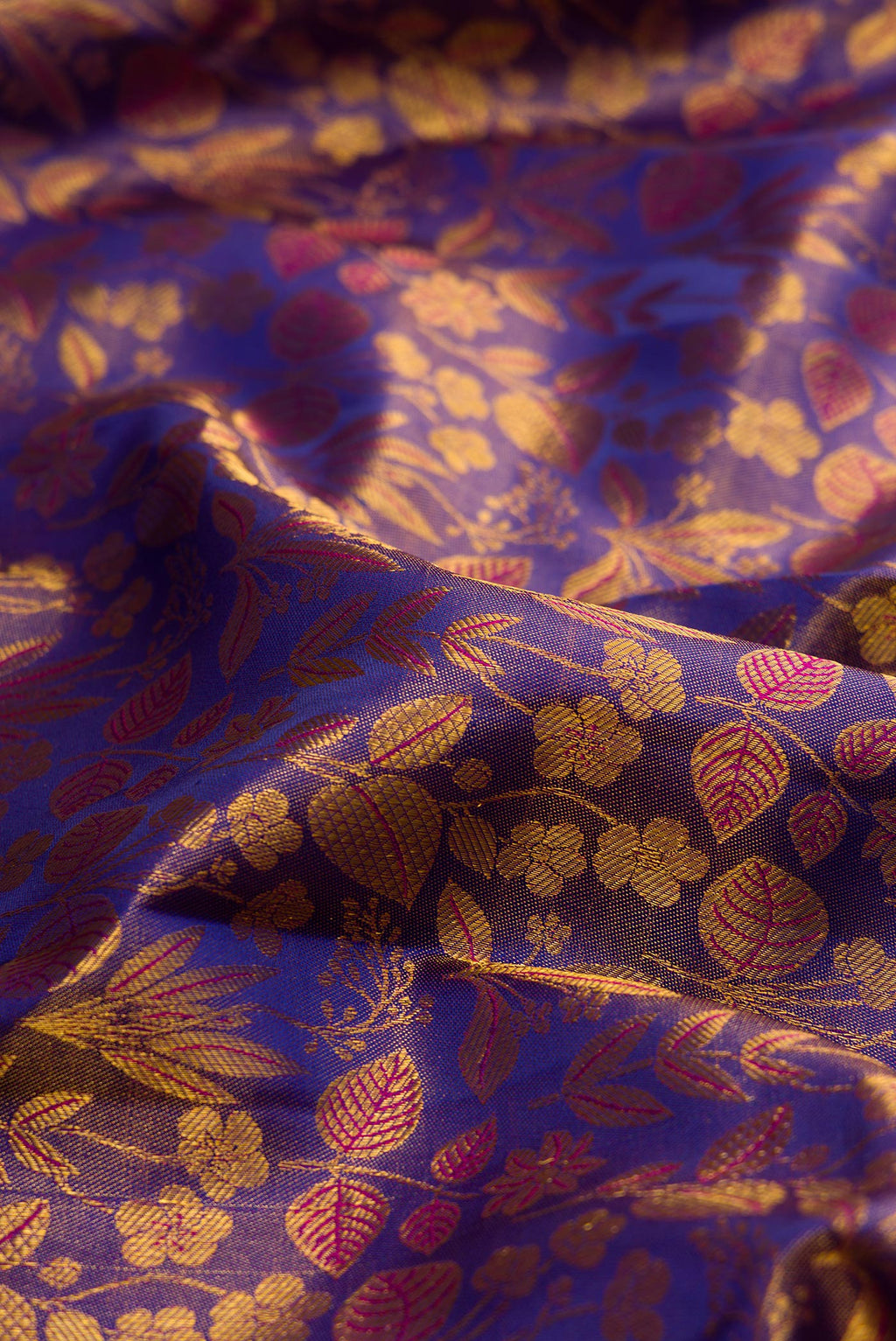 Close up of Pure Silk Purple Dual Tone Kanchipuram Tissue Saree with Zari Brocade on the body and Zari Border.  displaying folds