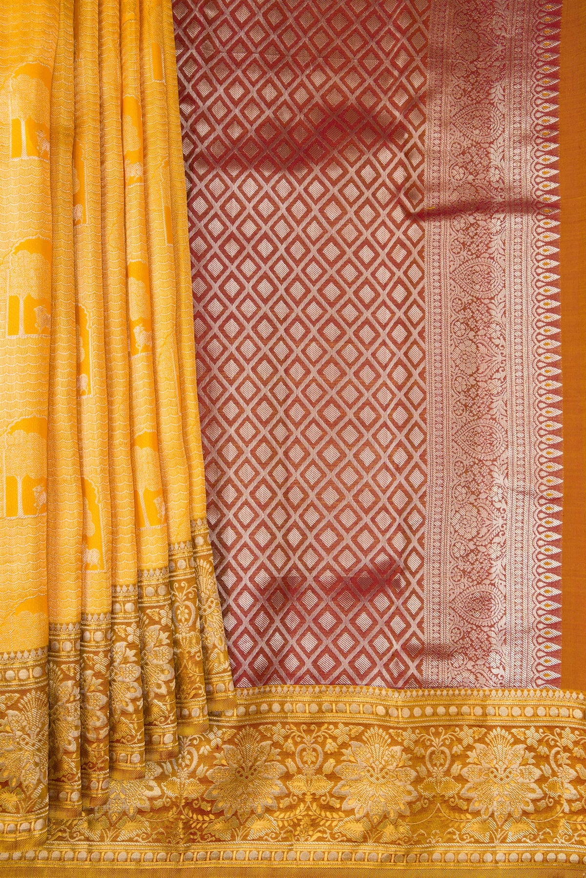 Pleats and pallu of Yellow Kanchipuram Tissue Saree with Zari Brocade on the body and Fancy Border. 