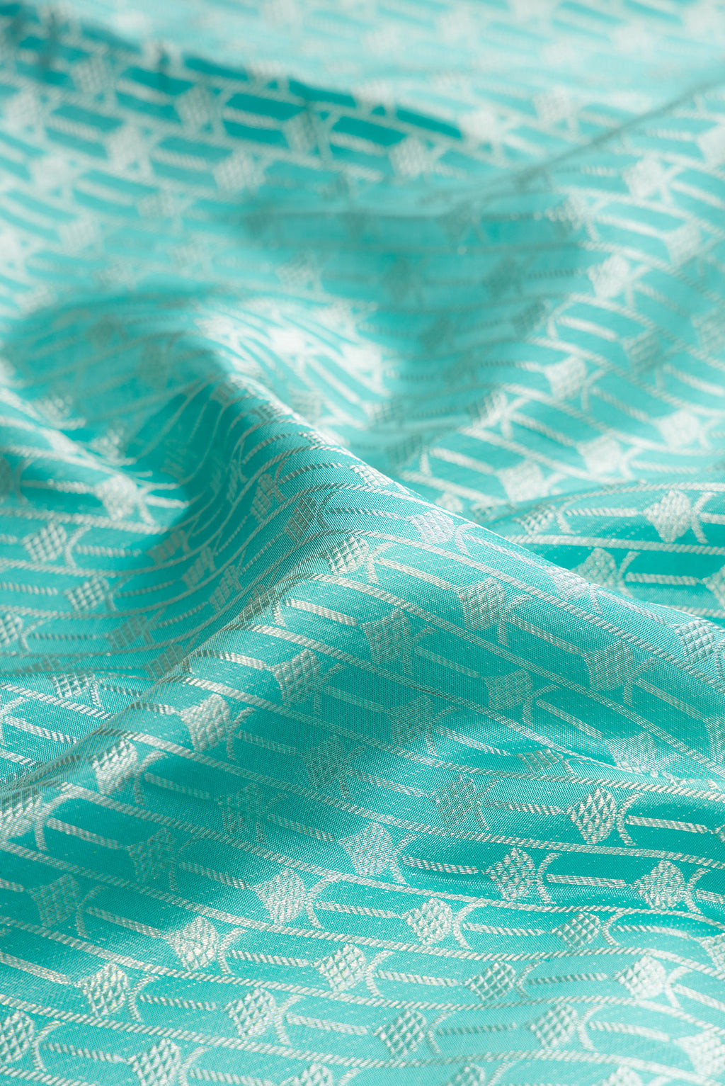 Close up of Pure Silk Light Blue Kanjivaram Tissue Saree with Zari Brocade on the body and Zari Border.  displaying folds