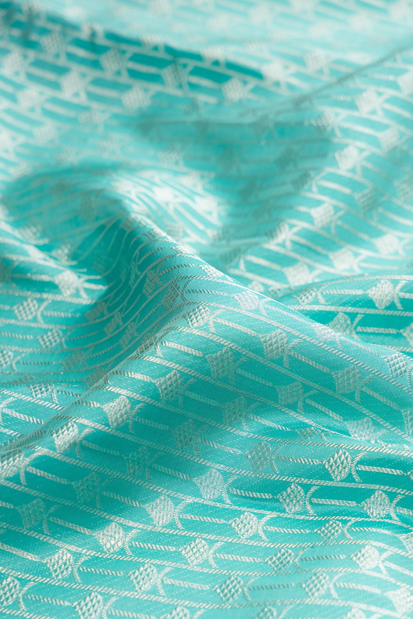 Close up of Pure Silk Light Blue Kanjivaram Tissue Saree with Zari Brocade on the body and Zari Border.  displaying folds