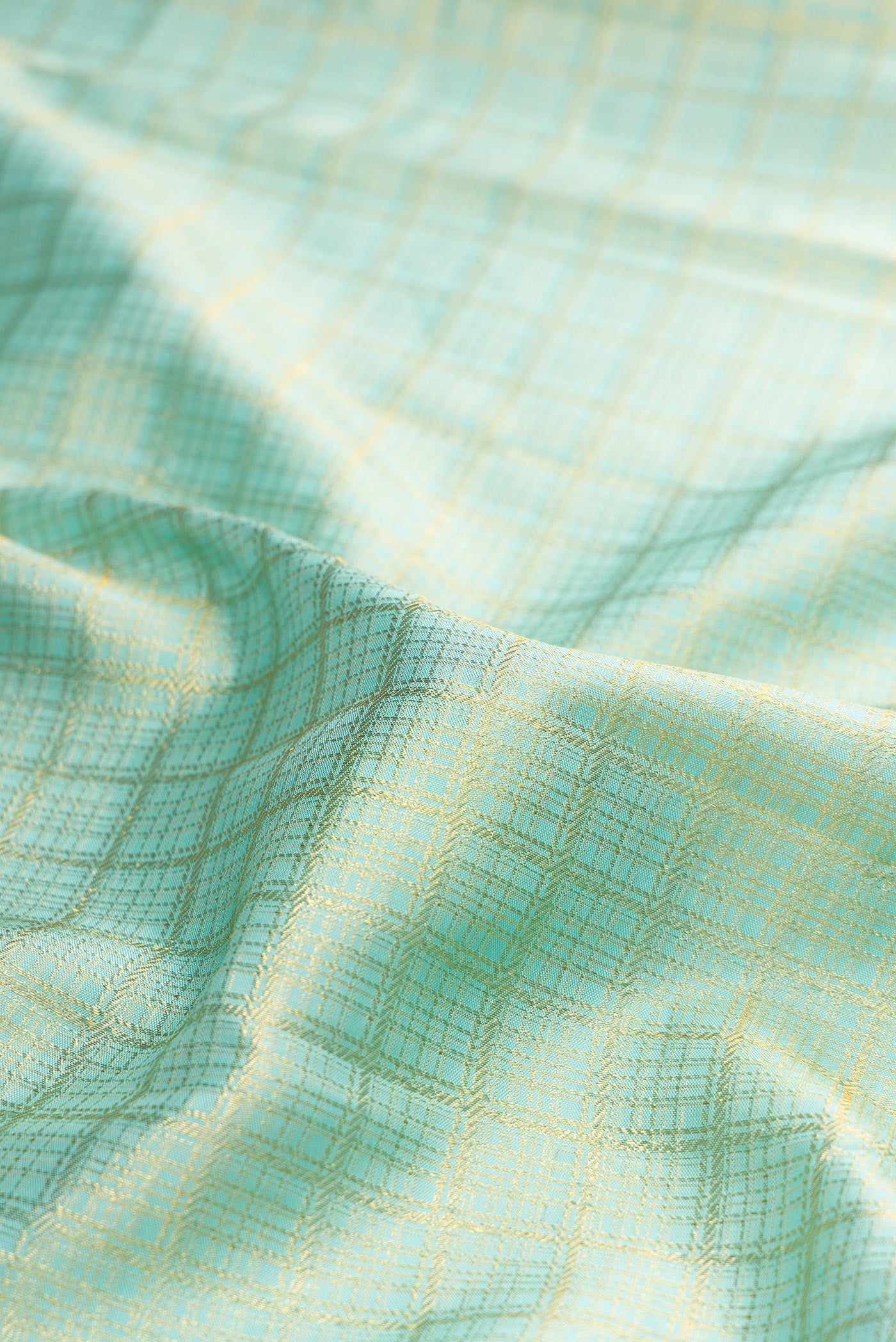 Close up of Pure Silk Light Blue Kanjivaram Saree with Zari Brocade on the body and Zari Border.  displaying folds