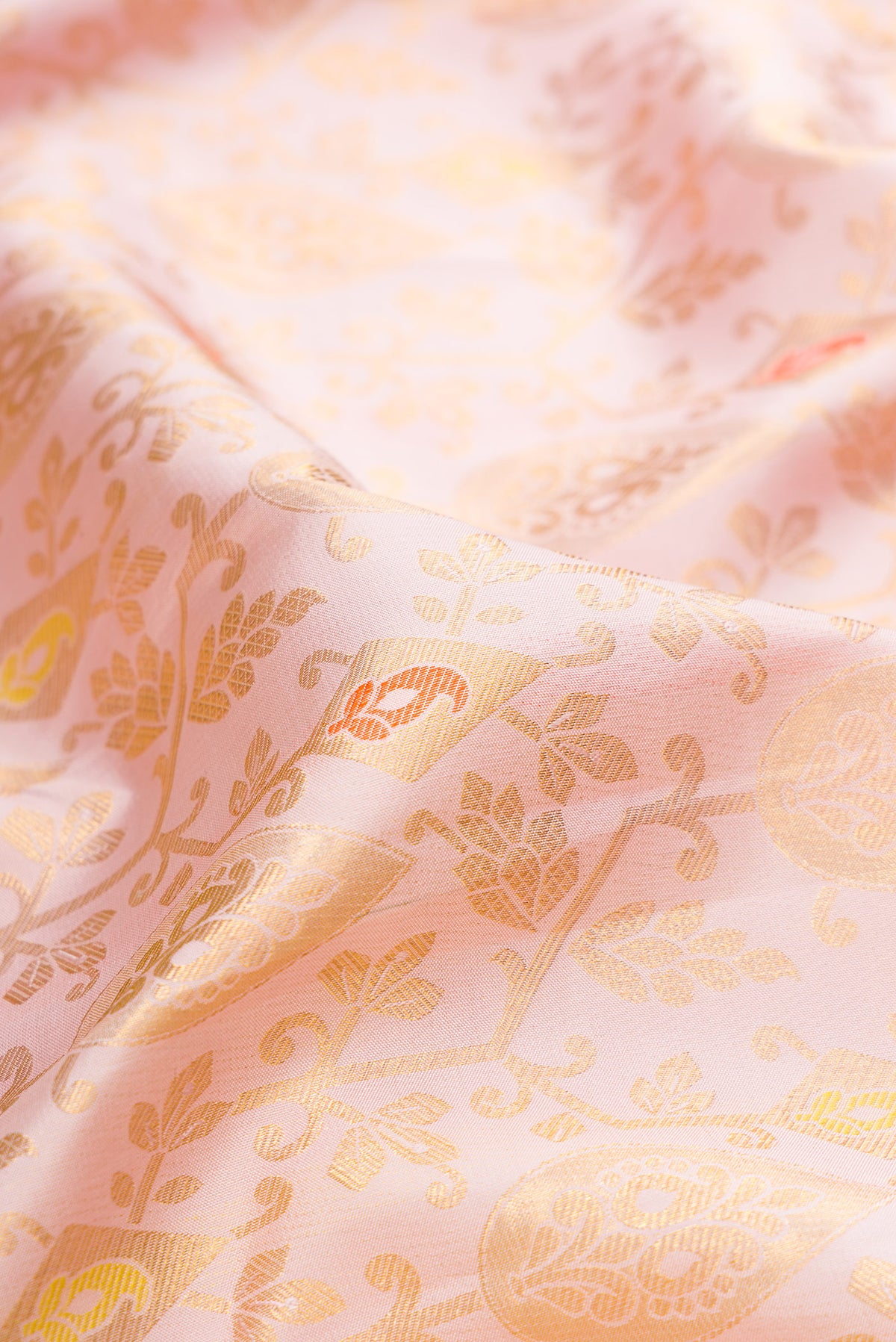 Close up of Pure Silk Rose Gold Dual Tone Kanjivaram Saree with Zari Brocade on the body and Zari Border.  displaying folds