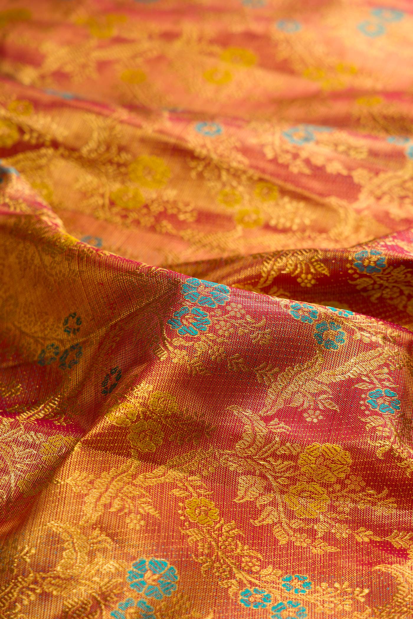 Close up of Pure Silk Maroon Dual Tone Kanjivaram Tissue Saree with Zari Brocade on the body and Zari Border.  displaying folds