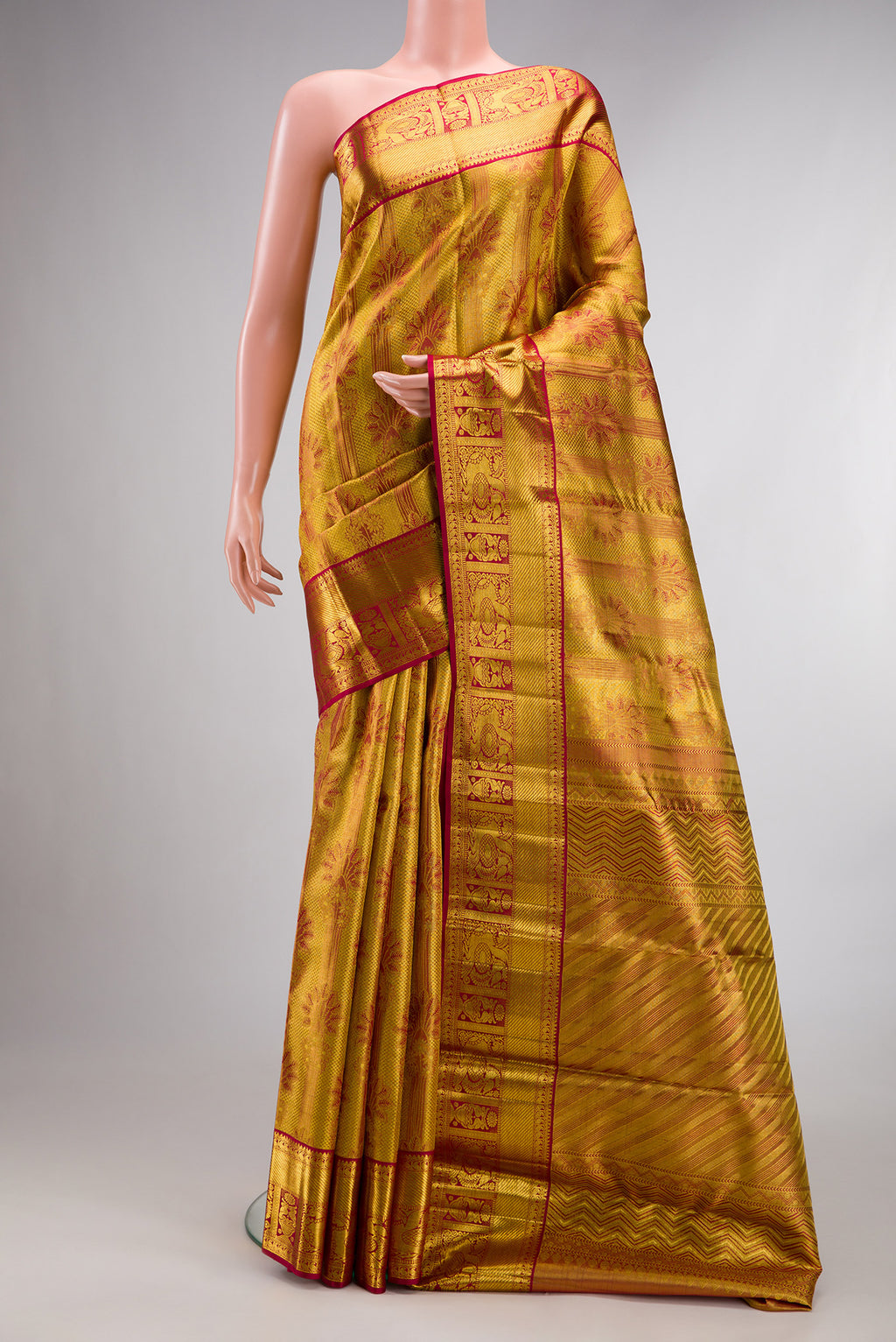 Gold Dual Tone Kanchipuram Tissue Saree with Zari Brocade on the body and Zari Border.  displayed on a mannequin