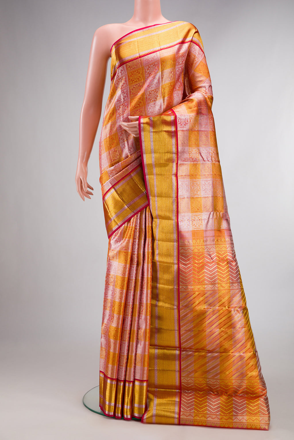 Multi Color Kanchipuram Tissue Saree with Zari Brocade on the body and Zari Border.  displayed on a mannequin