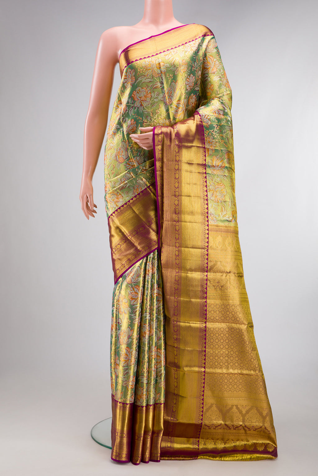 Pure Silk Pista Green Dual Tone Kanchipuram Tissue Saree with Zari Brocade on the body and Zari Border.  displayed on a mannequin