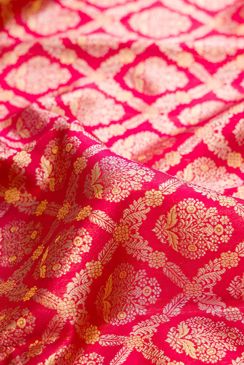 Close up of Dark Pink Dual Tone Kanchipuram Tissue Saree with Zari Brocade on the body and Fancy Border.  displaying folds