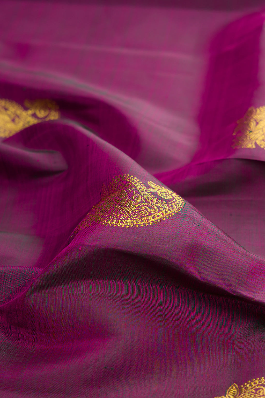 Close up of Pure Silk Purple Kanjivaram Saree with Zari Butta on the body and Zari Border.  displaying folds