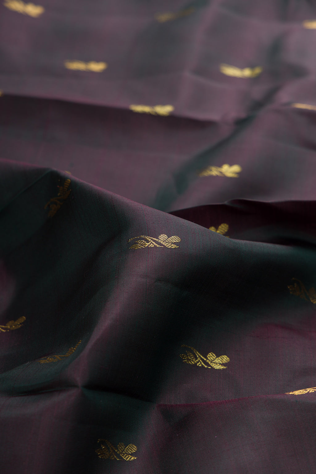 Close up of Pure Silk Bottle Green with Maroon Color Kanjivaram Saree with Zari Butta on the body and Zari Border.  displaying folds