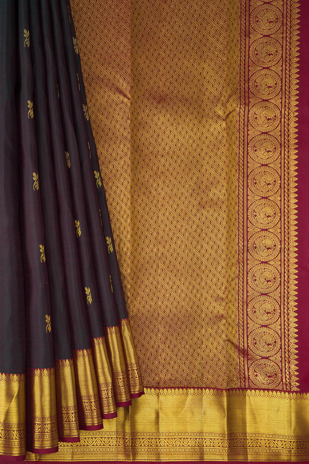 Pleats and pallu of Pure Silk Bottle Green with Maroon Color Kanjivaram Saree with Zari Butta on the body and Zari Border. 