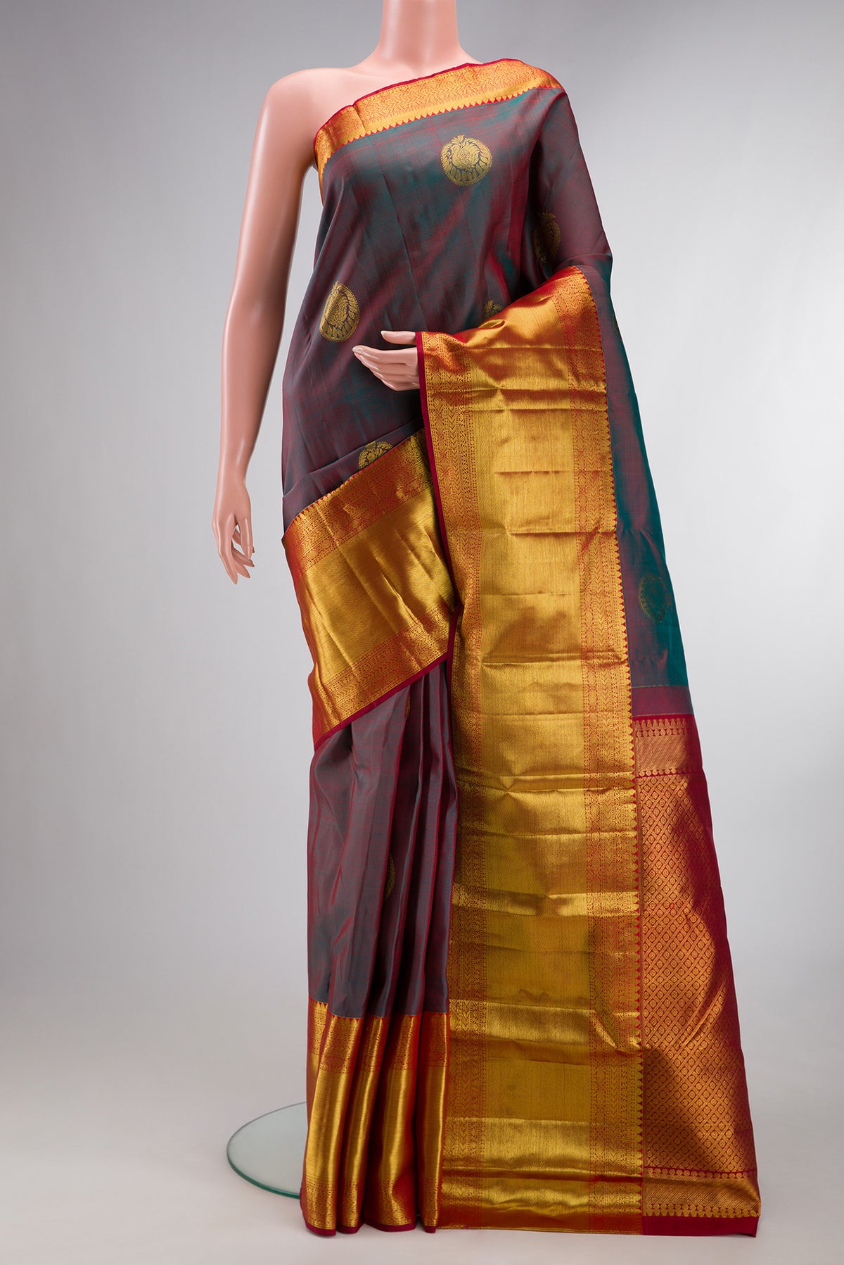 Pure Silk Green with Red Color Kanchipuram Saree with Zari Butta on the body and Zari Border.  displayed on a mannequin