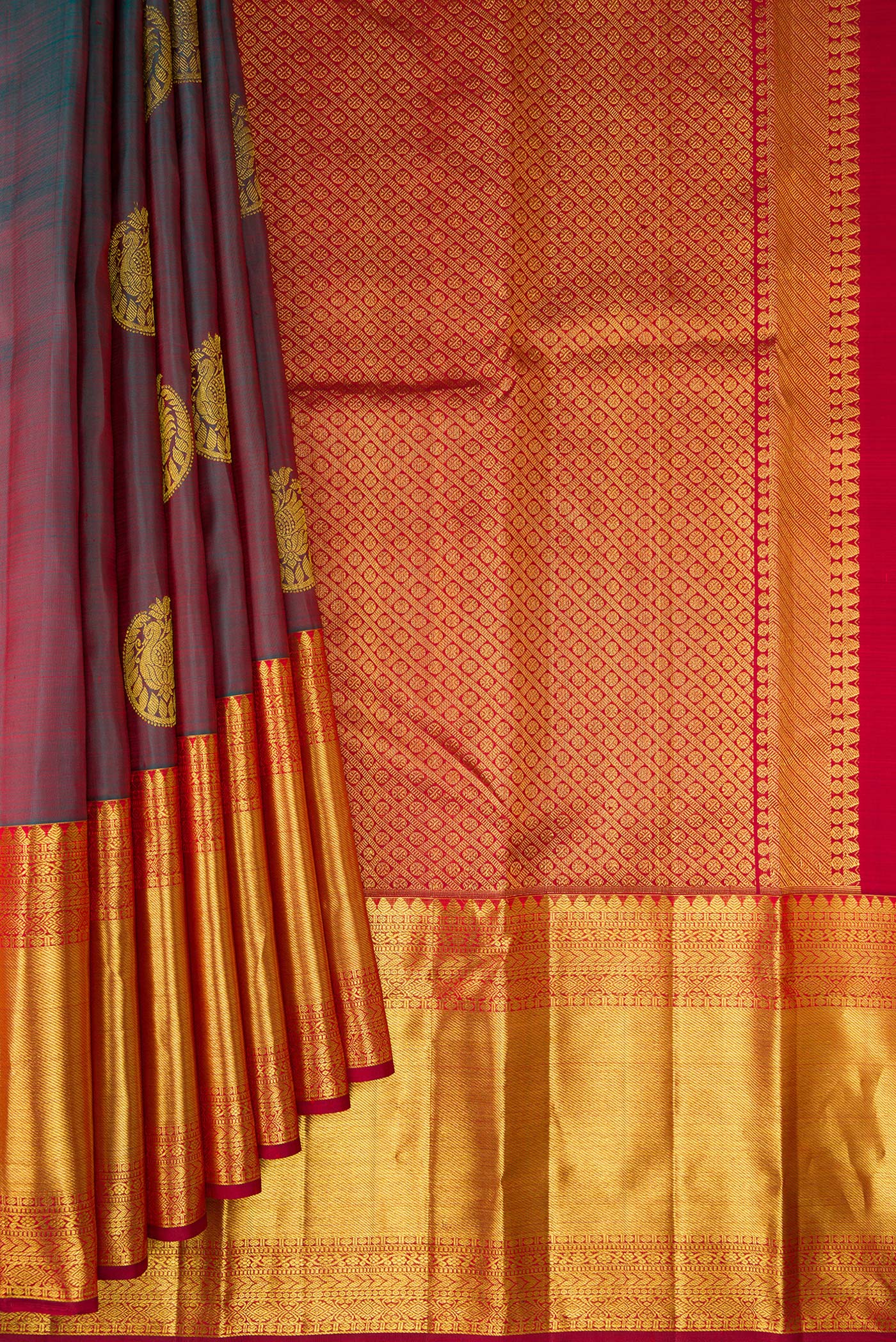 Pleats and pallu of Pure Silk Green with Red Color Kanchipuram Saree with Zari Butta on the body and Zari Border. 