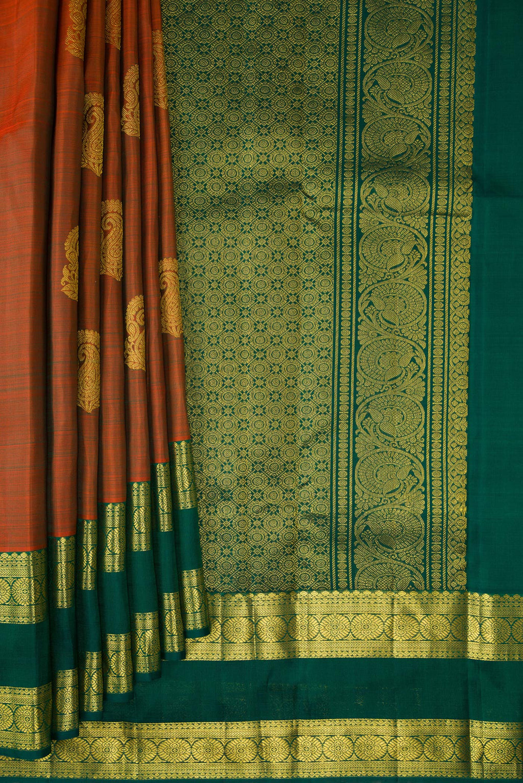 Pleats and pallu of Pure Silk Rust Kanchipuram Saree with Zari Butta on the body and Zari Border. 