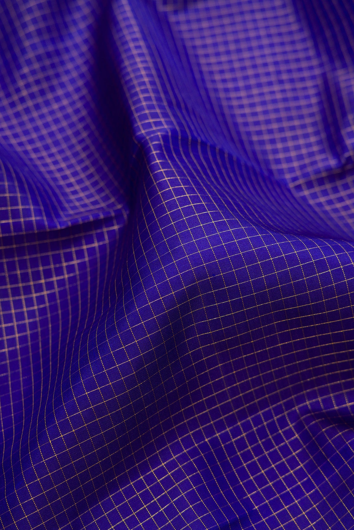 Close up of Pure Silk Dark Blue Kanjivaram Saree with Checked design on the body and Zari Border.  displaying folds