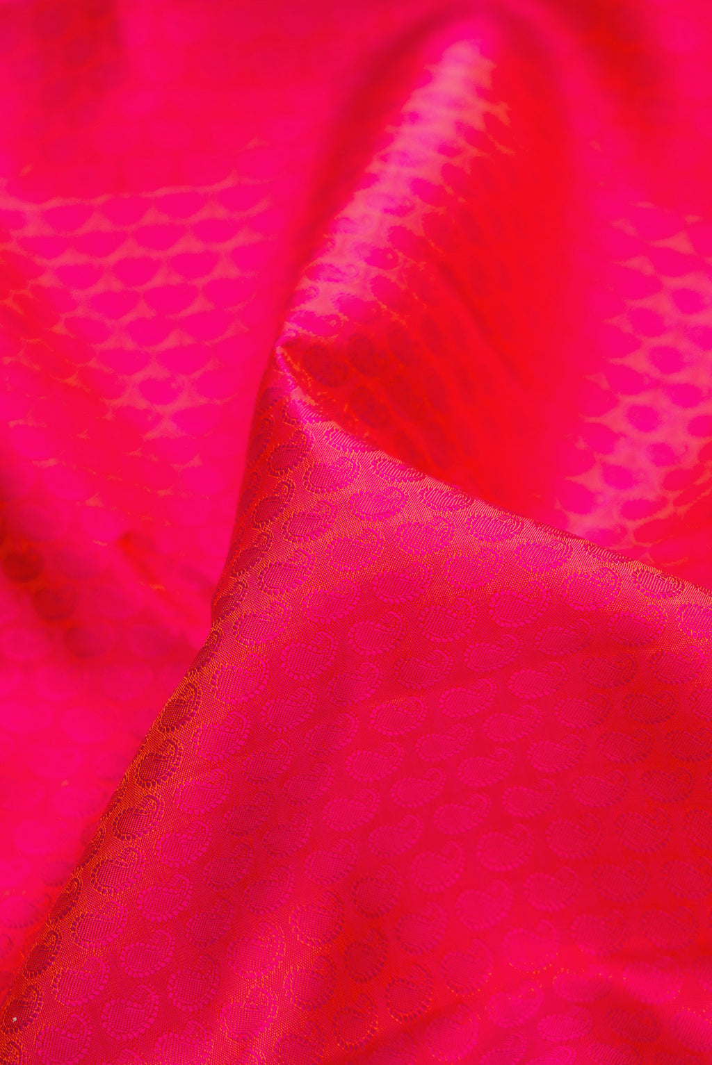Close up of Pure Silk Pink Dual Tone Kanchipuram Saree with Jacquard design on the body and Zari Border.  displaying folds