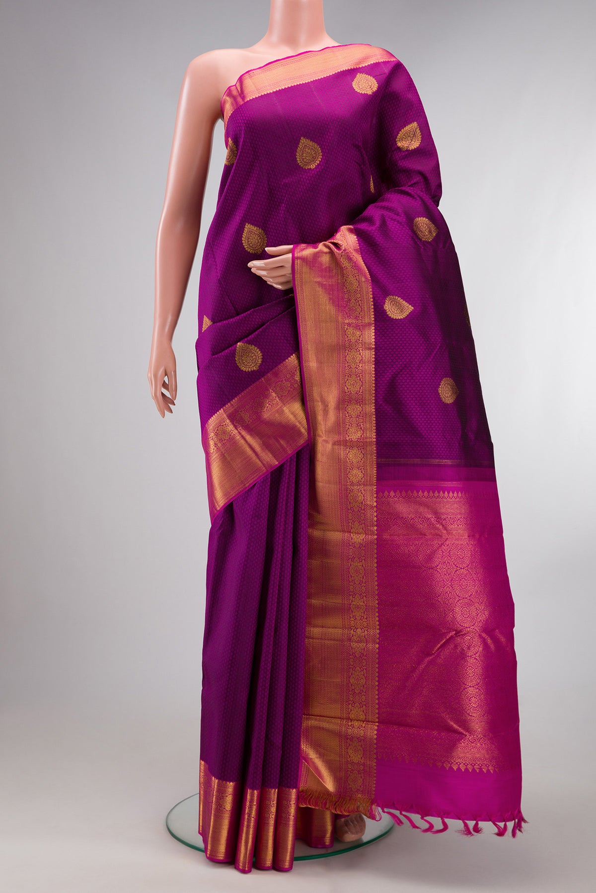 Pure Silk Magenta Kanchipuram Saree with Jacquard With Zari Butta on the body and Zari Border.  displayed on a mannequin
