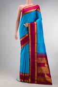 Pure Silk Sky Blue Kanjivaram Saree with Zari Butta on the body and Zari Border.  displayed on a mannequin