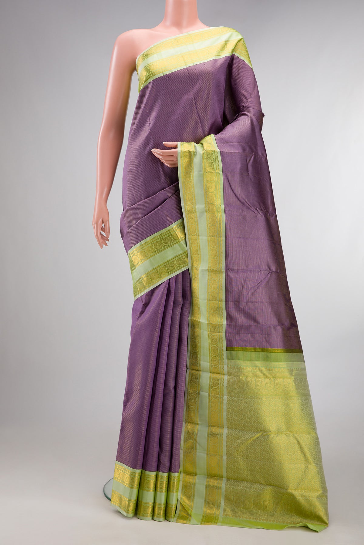 Pure Silk Mauve Kanjivaram Saree with Stripes on the body and Zari Border.  displayed on a mannequin