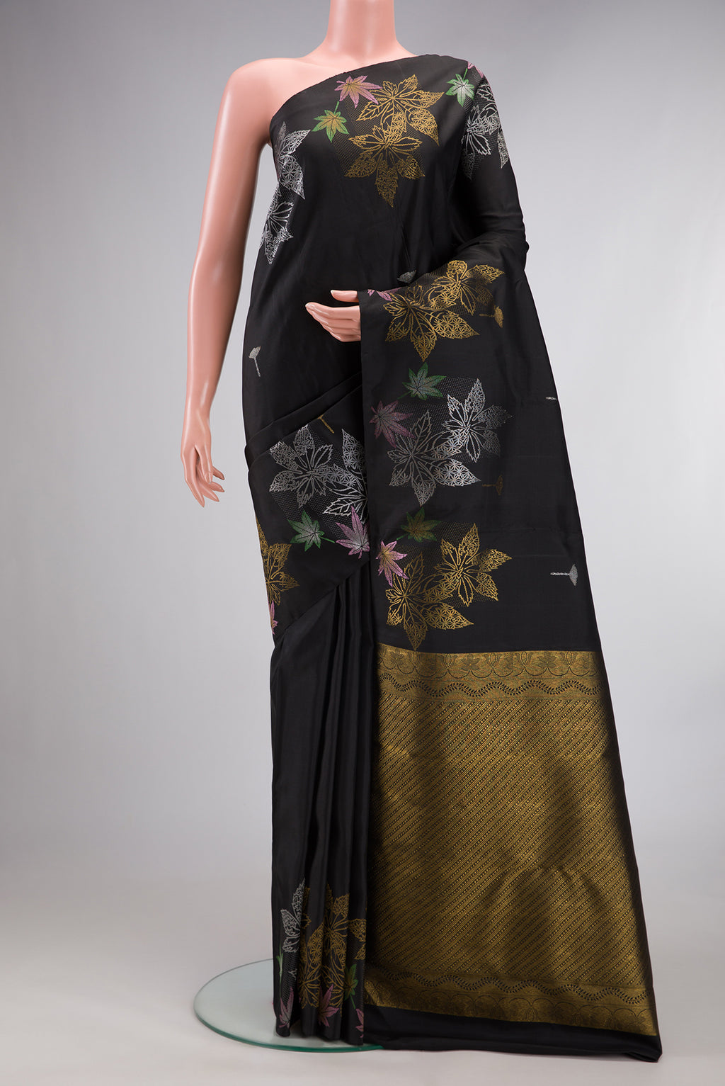 Pure Silk Black Kanchipuram Saree with Zari Butta on the body and Without Border.  displayed on a mannequin