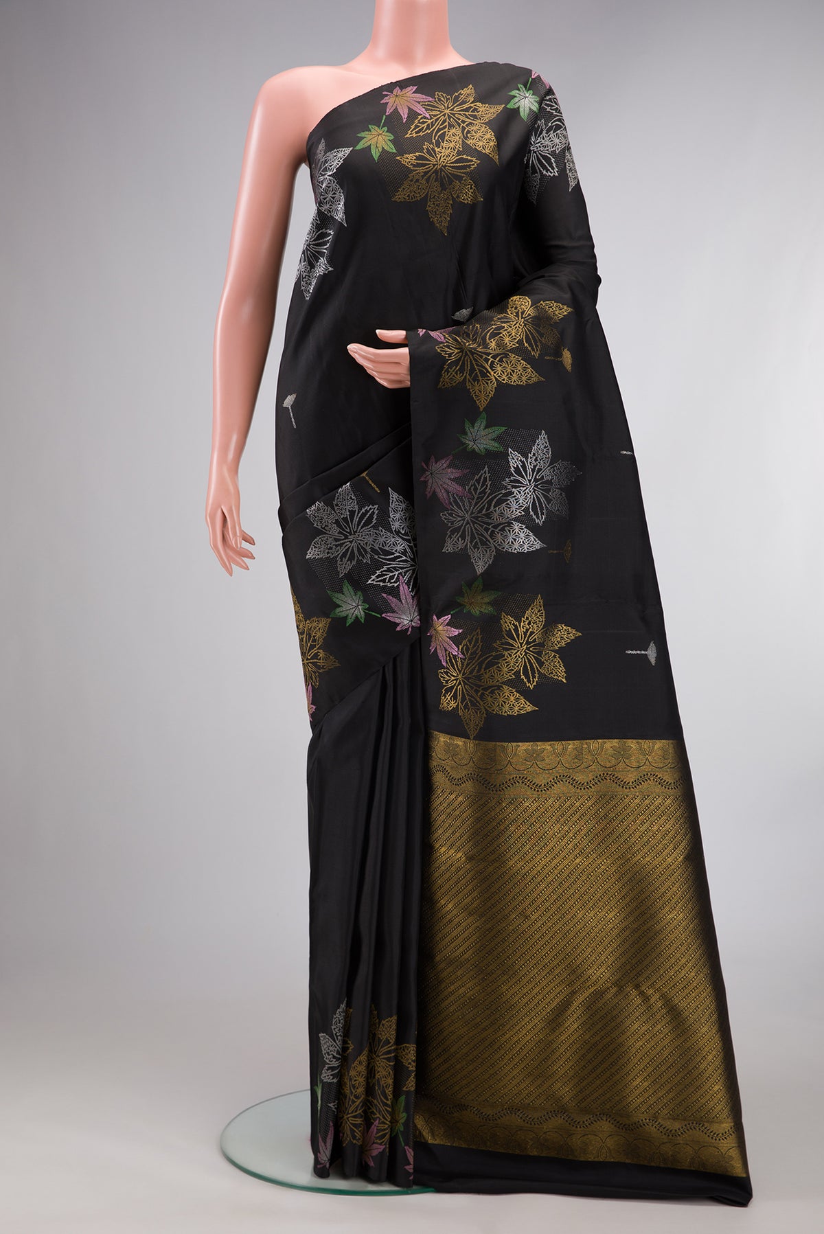 Pure Silk Black Kanchipuram Saree with Zari Butta on the body and Without Border.  displayed on a mannequin