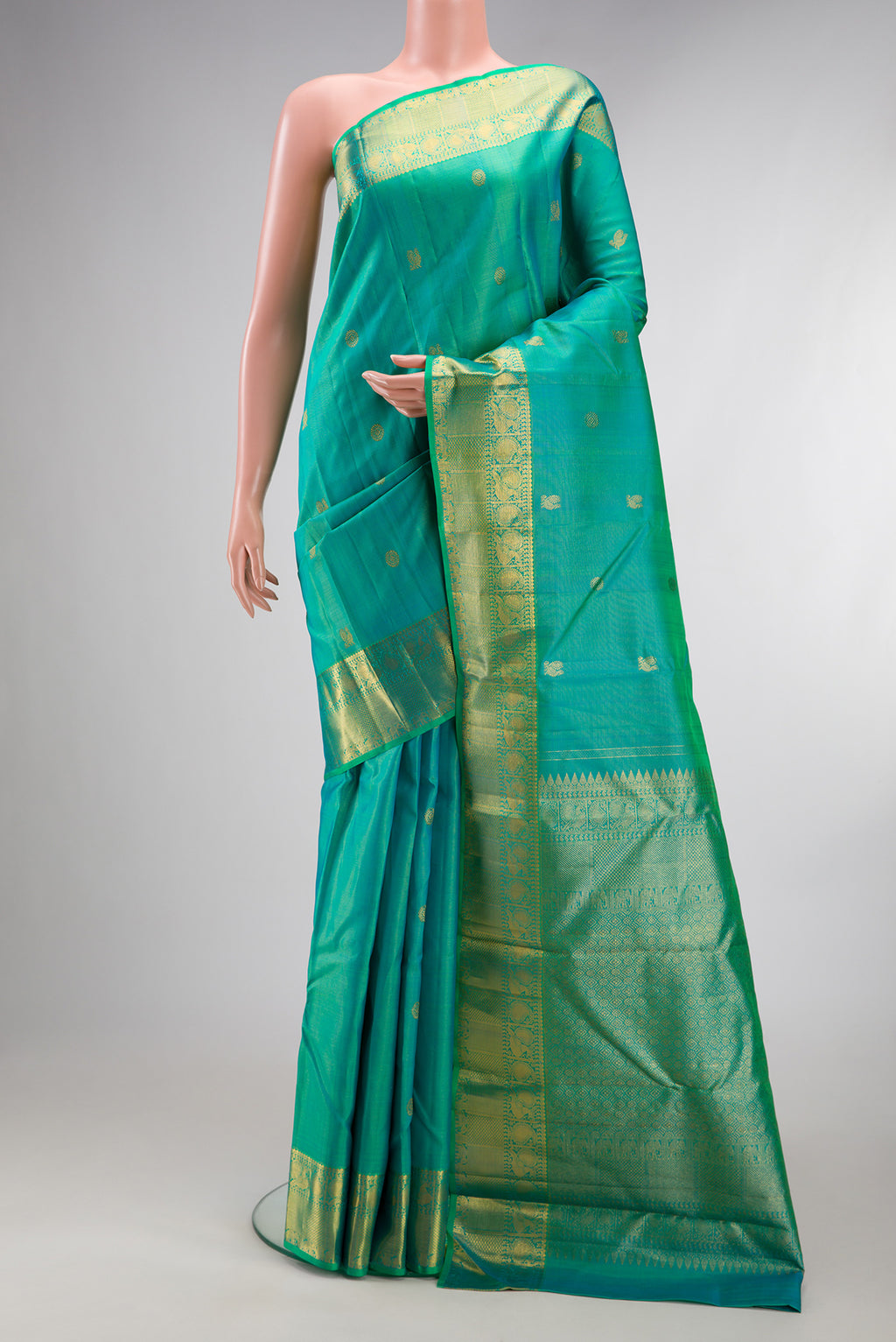 Pure Silk Turquoise Kanjivaram Saree with Zari Butta on the body and Zari Border.  displayed on a mannequin