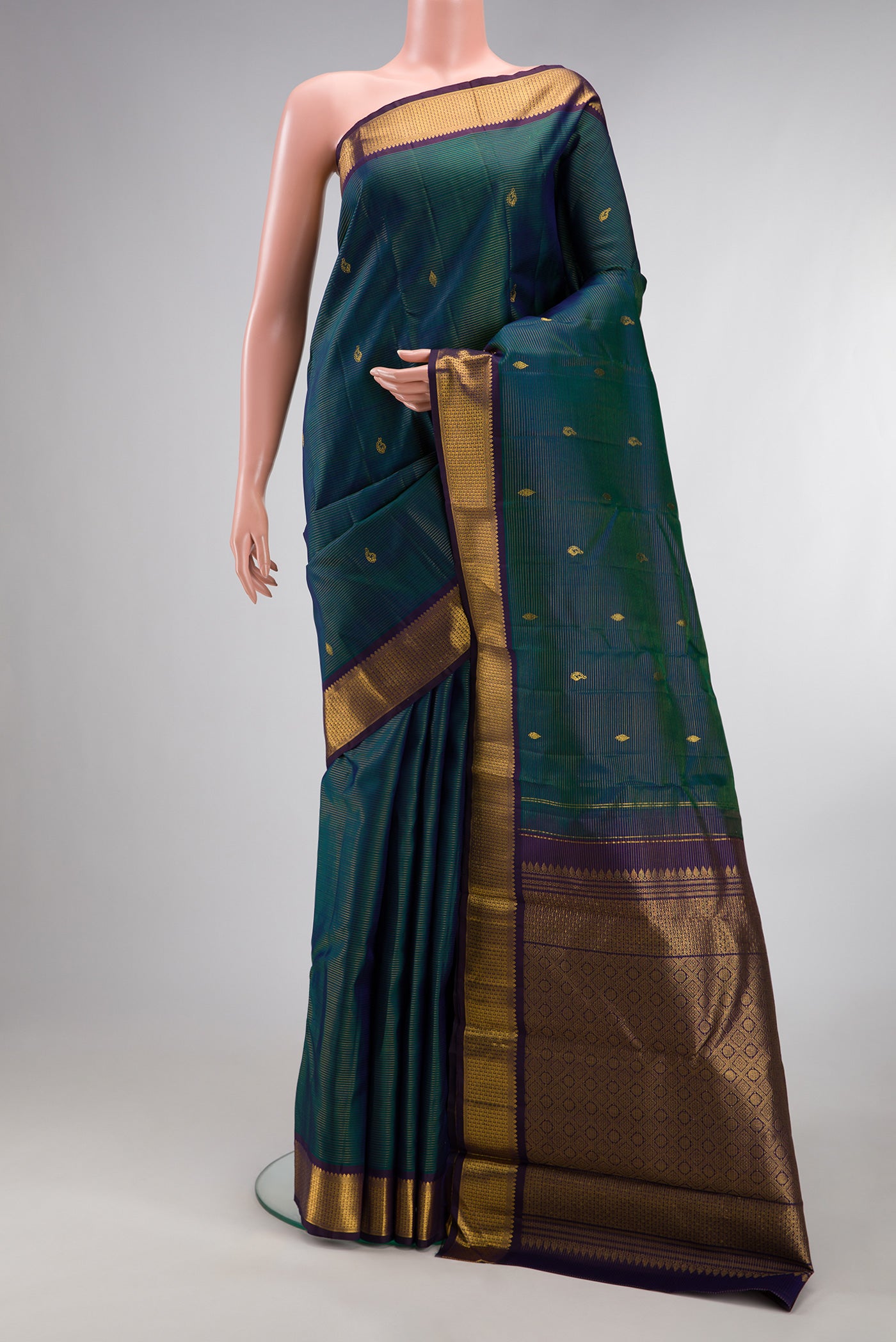 Pure Silk Peacock Blue Kanjivaram Saree with Stripes on the body and Zari Border.  displayed on a mannequin