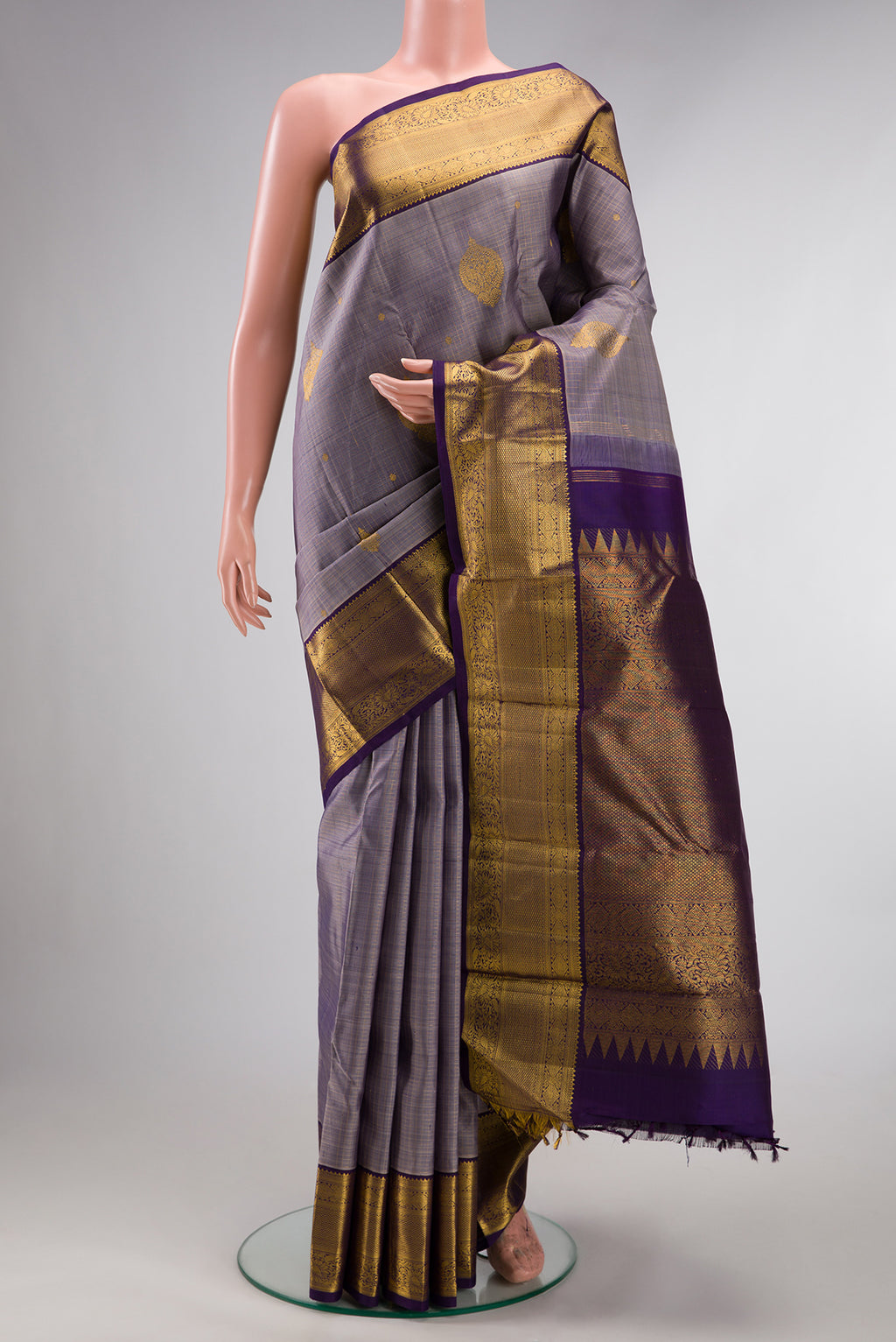 Pure Silk Lilac Dual Tone Kanjivaram Saree with Zari Butta on the body and Zari Border.  displayed on a mannequin
