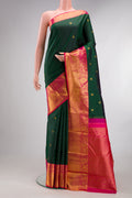Pure Silk Bottle Green Kanjivaram Saree with Zari Butta on the body and Zari Border.  displayed on a mannequin
