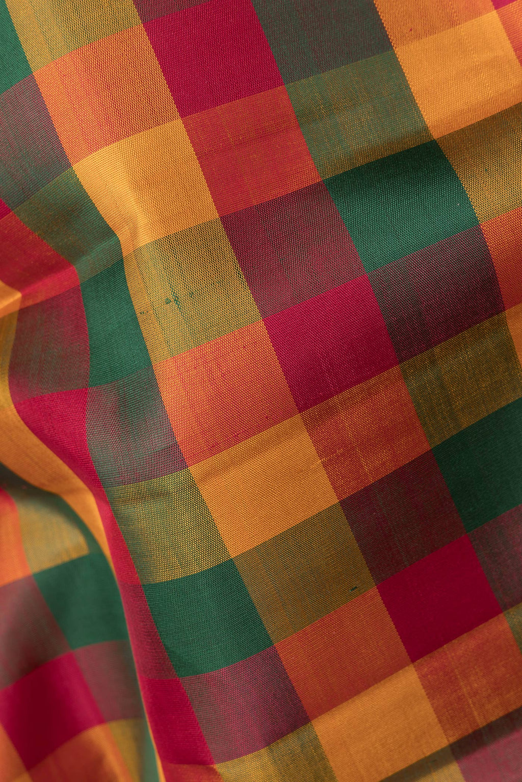 Close up of Pure Silk Multi Color Kanchipuram Saree with Checked design on the body and Zari Border.  displaying folds
