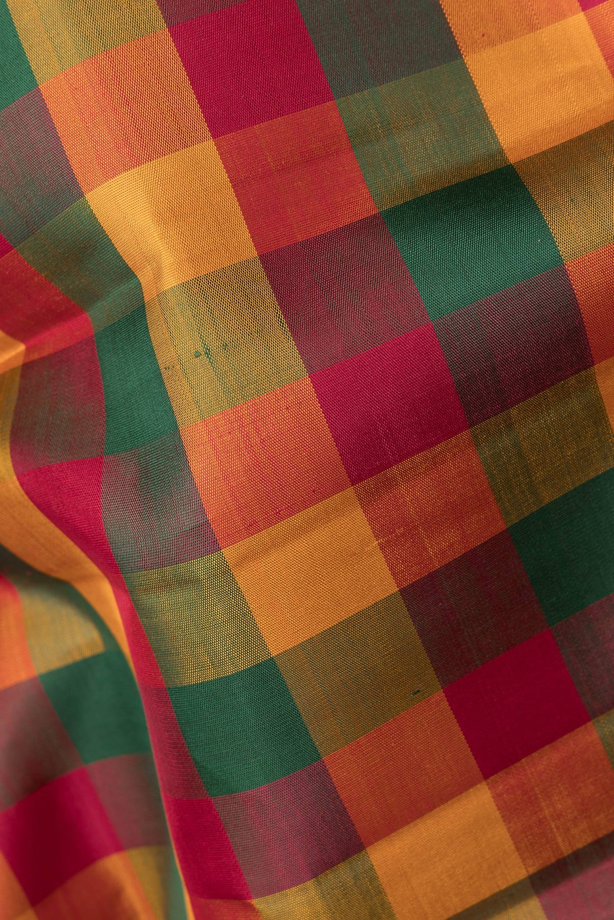 Close up of Pure Silk Multi Color Kanchipuram Saree with Checked design on the body and Zari Border.  displaying folds