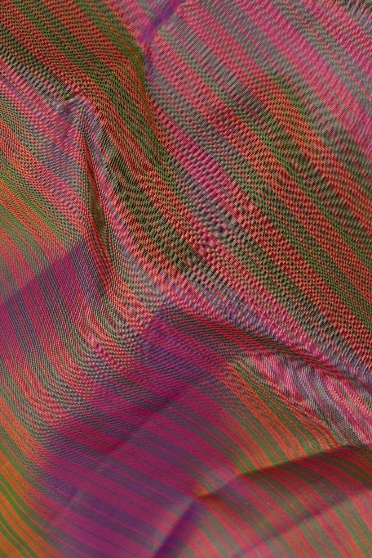 Close up of Pure Silk Multi Color Kanchipuram Saree with Stripes on the body and Zari Border.  displaying folds
