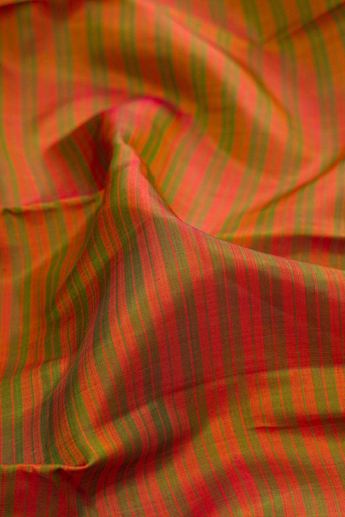Close up of Pure Silk Mehandi Green Dual Tone Kanchipuram Saree with Stripes on the body and Zari Border.  displaying folds
