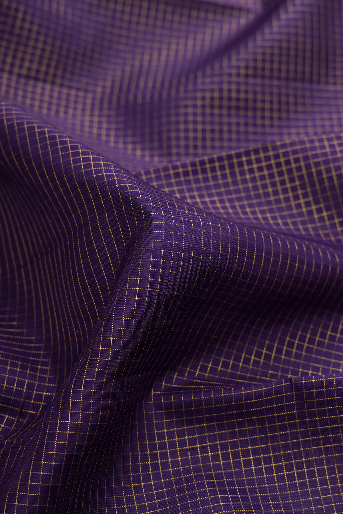 Close up of Pure Silk Navy Blue Kanchipuram Saree with Checked design on the body and Zari Border.  displaying folds