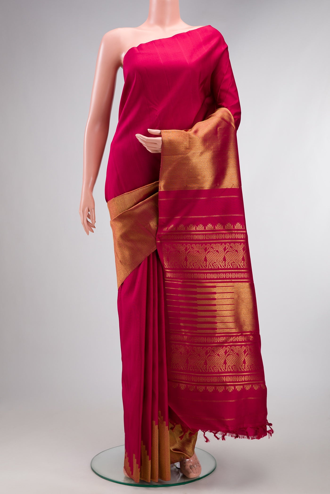 Pure Silk Pure Zari Maroon Kanjivaram Saree with Plain Body and Rising Temple Border.  displayed on a mannequin