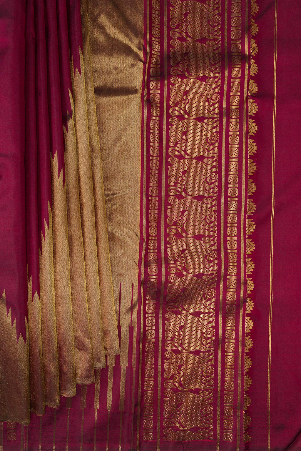 Pleats and pallu of Pure Silk Pure Zari Maroon Kanjivaram Saree with Plain Body and Rising Temple Border. 