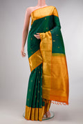 Pure Silk Pure Zari Green Dual Tone Kanjivaram Saree with Zari Butta on the body and Zari Border.  displayed on a mannequin