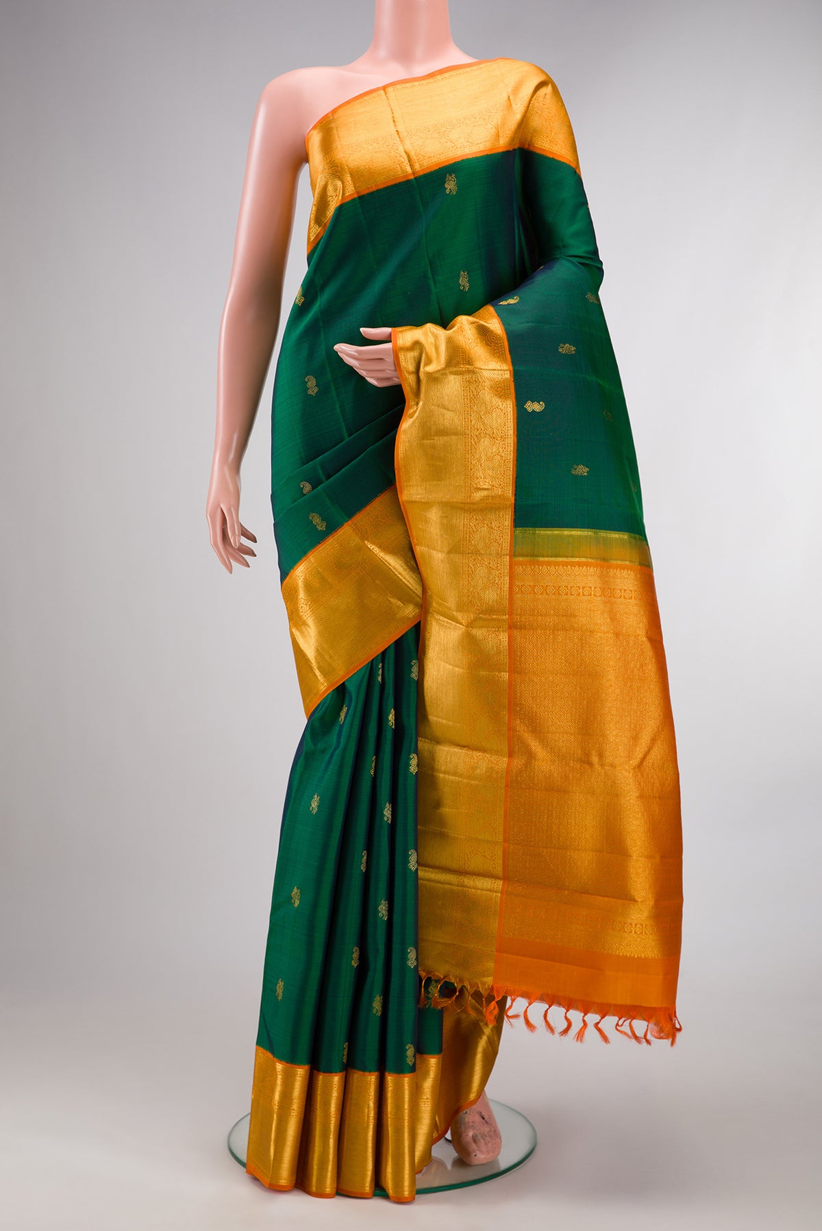 Pure Silk Pure Zari Green Dual Tone Kanjivaram Saree with Zari Butta on the body and Zari Border.  displayed on a mannequin