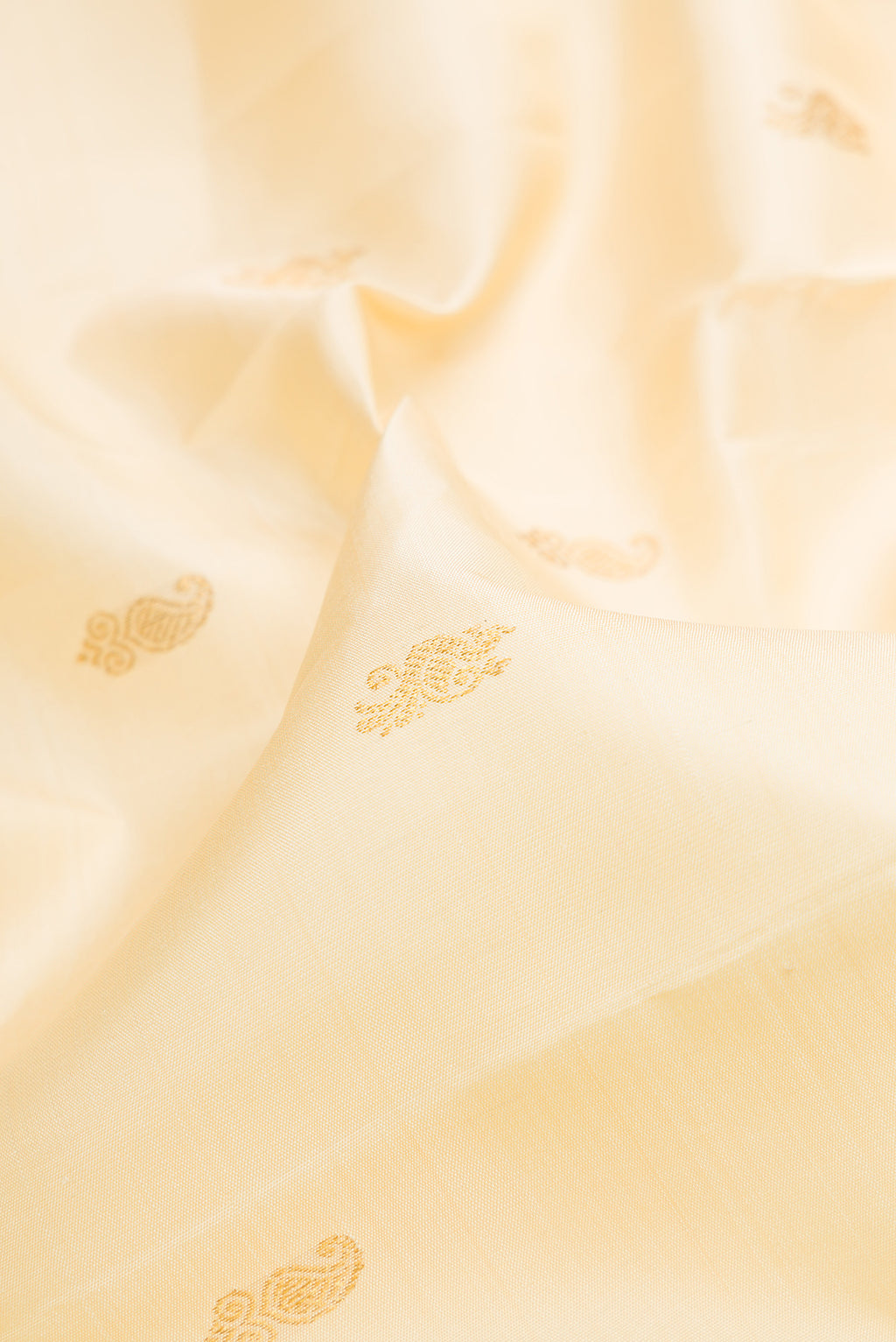 Close up of Pure Silk Sandal Kanjivaram Saree with Zari Butta on the body and Zari Border.  displaying folds