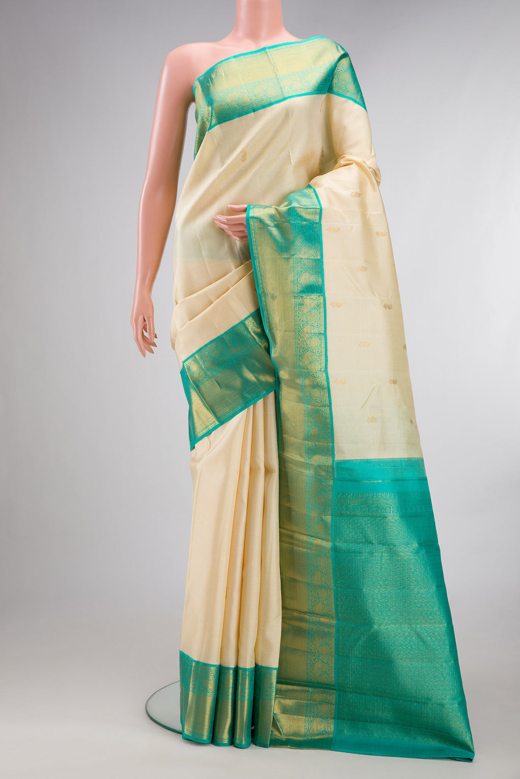 Pure Silk Sandal Kanjivaram Saree with Zari Butta on the body and Zari Border.  displayed on a mannequin