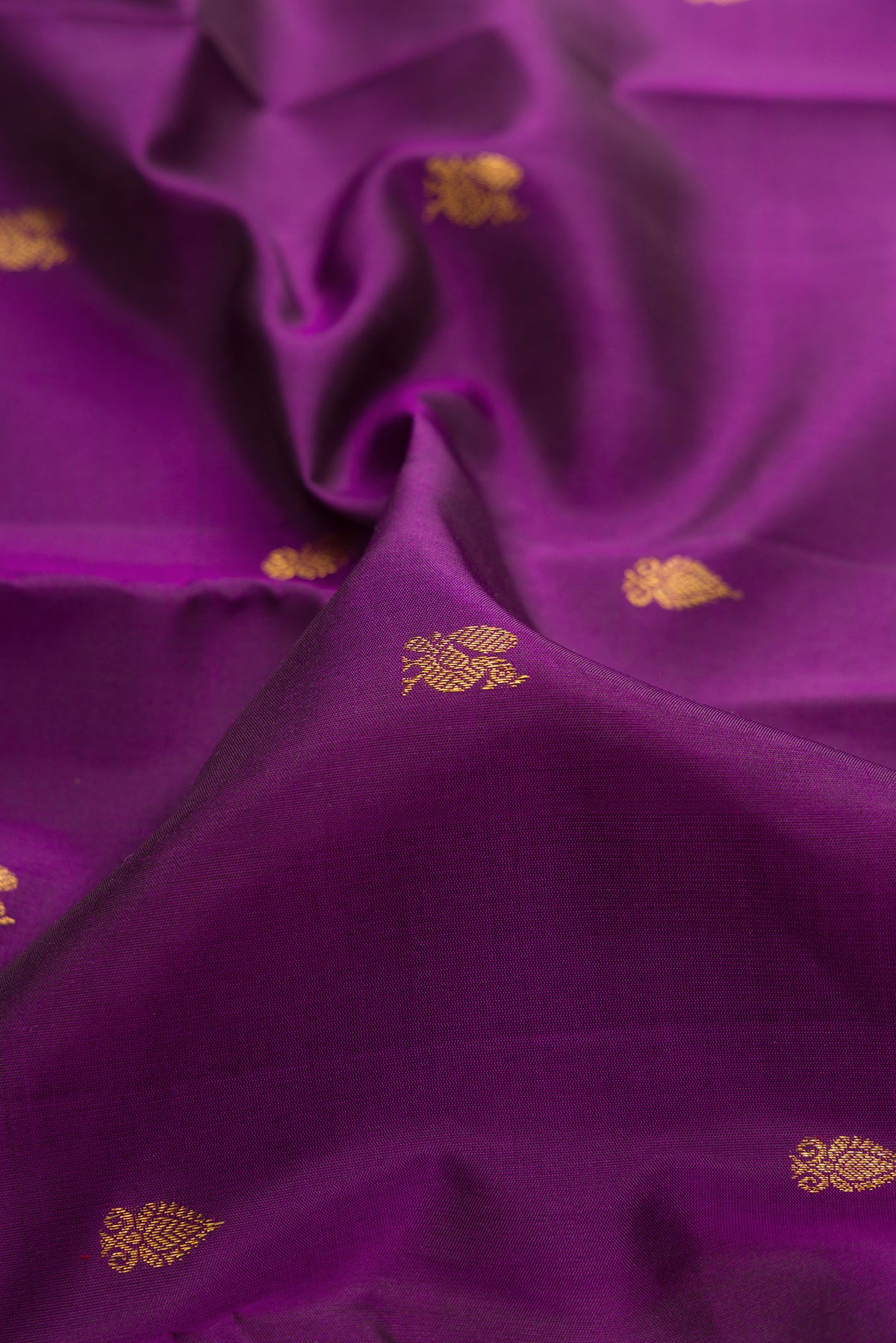 Close up of Pure Silk Purple Kanjivaram Saree with Zari Butta on the body and Fancy Border.  displaying folds
