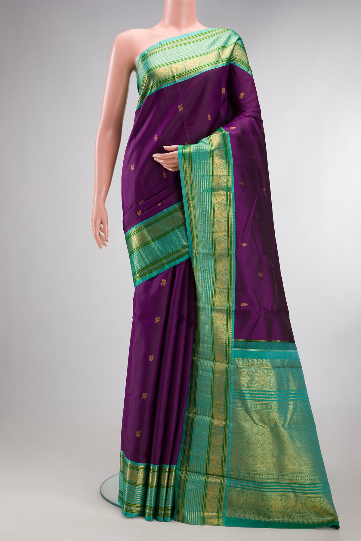 Pure Silk Purple Kanjivaram Saree with Zari Butta on the body and Fancy Border.  displayed on a mannequin