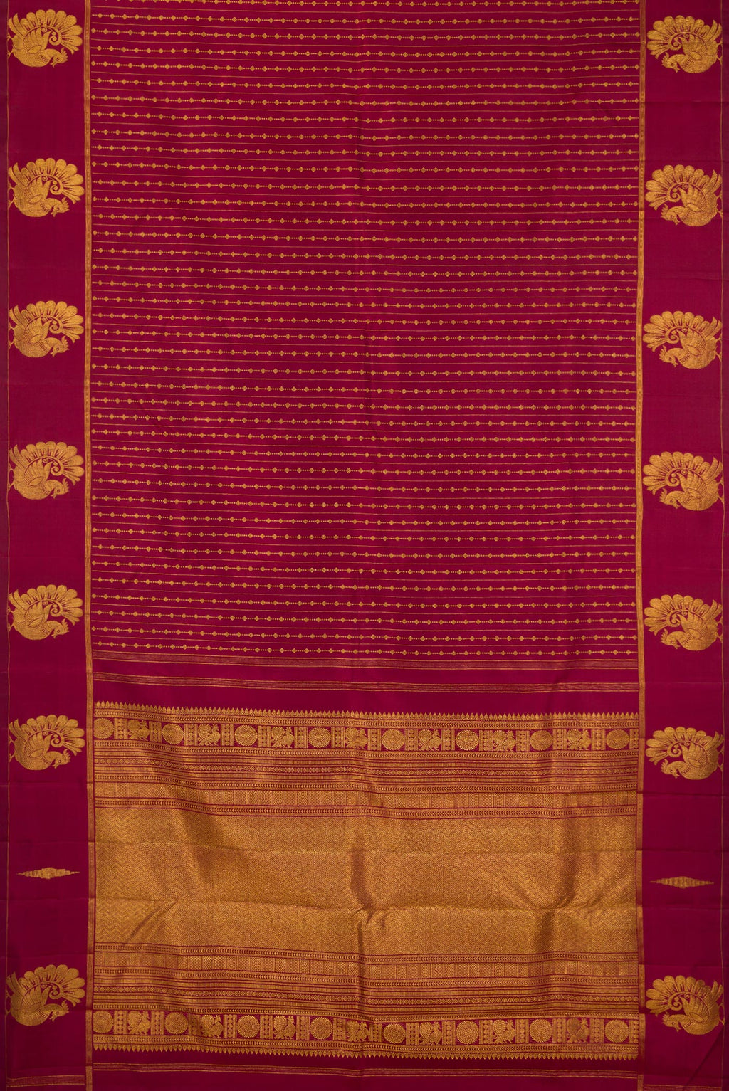 Flat view of Pure Silk Maroon Kanjivaram Saree with Zari Butta on the body and Fancy Border. 