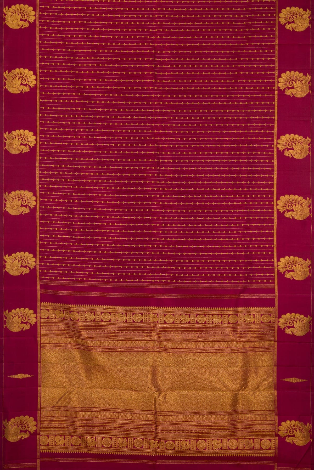 Flat view of Pure Silk Maroon Kanjivaram Saree with Zari Butta on the body and Fancy Border. 