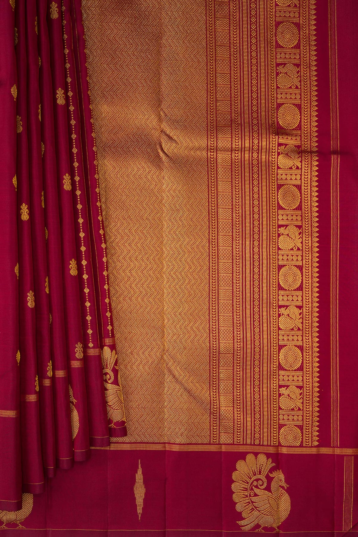 Pleats and pallu of Pure Silk Maroon Kanjivaram Saree with Zari Butta on the body and Fancy Border. 