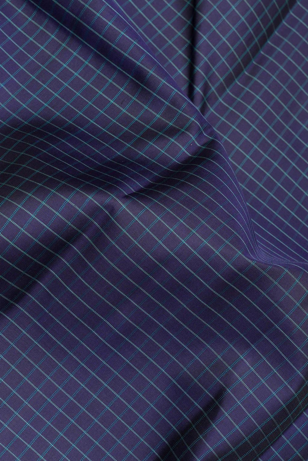 Close up of Pure Silk Navy Blue Dual Tone Kanjivaram Saree with Checked design on the body and Zari Border.  displaying folds
