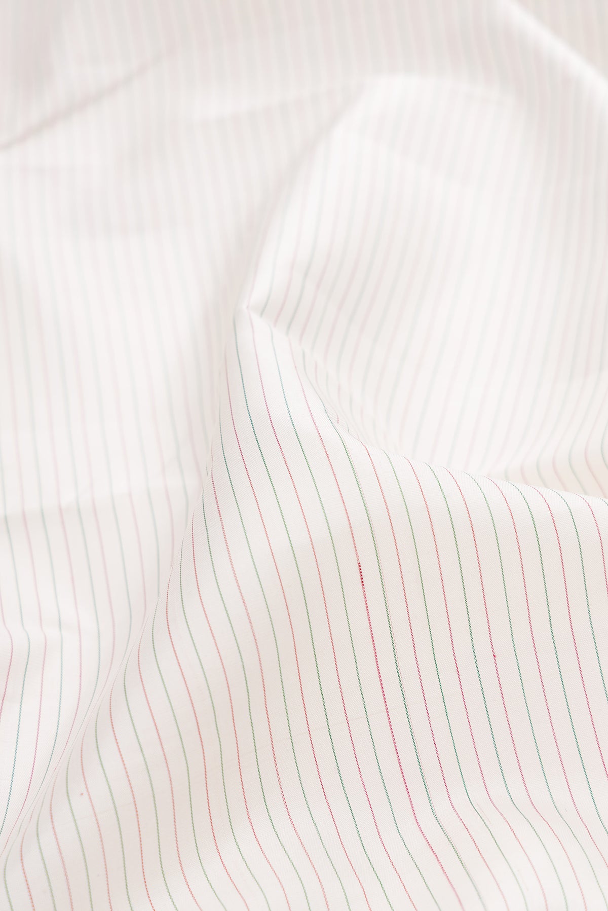 Close up of Pure Silk Pure Zari Off White Dual Tone Kanjivaram Saree with Stripes on the body and Ganga Jamuna Border.  displaying folds