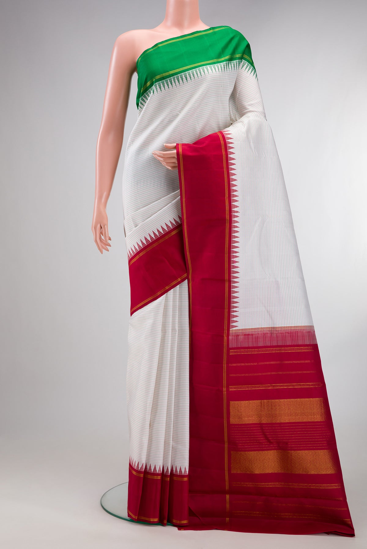 Pure Silk Pure Zari Off White Dual Tone Kanjivaram Saree with Stripes on the body and Ganga Jamuna Border.  displayed on a mannequin