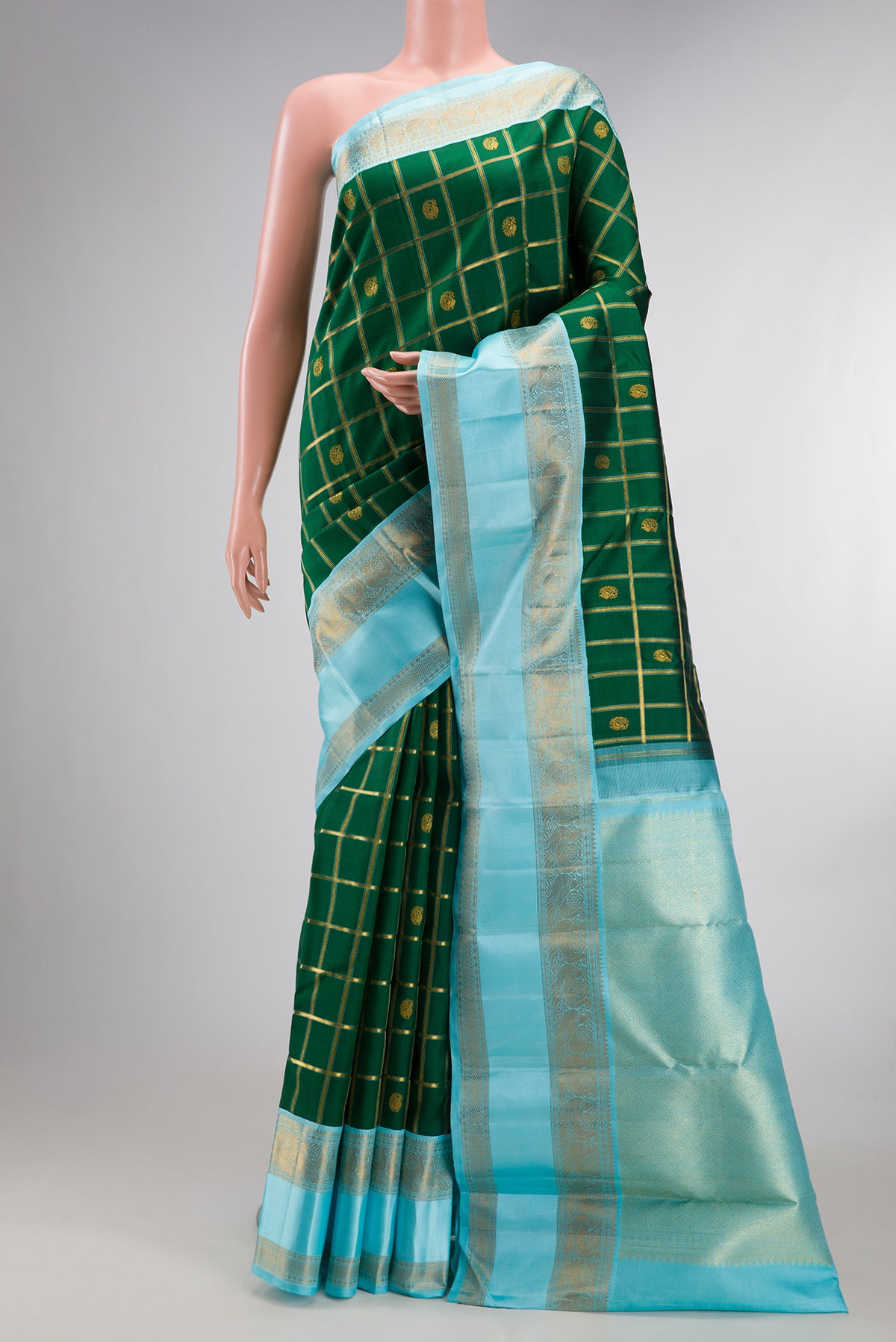 Pure Silk Bottle Green Kanchipuram Saree with Checked design on the body and Zari And Thread Border.  displayed on a mannequin