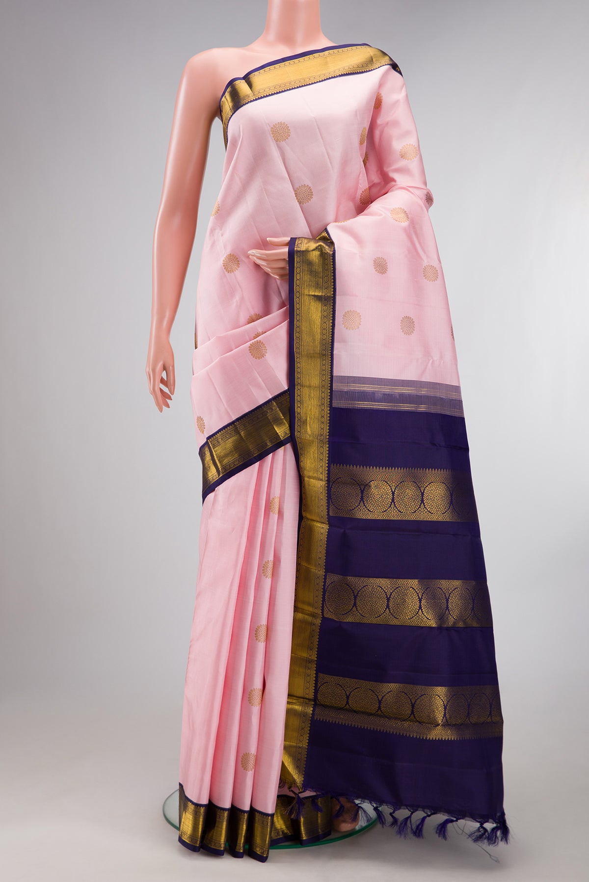 Pure Silk Rose pink Kanchipuram Saree with Zari Butta on the body and Zari Border.  displayed on a mannequin